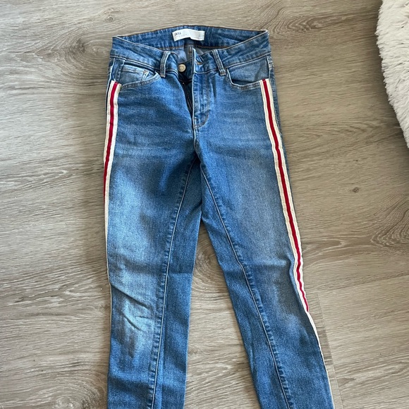 Never worn Zara skinny jeans with red and white strip down each pant leg